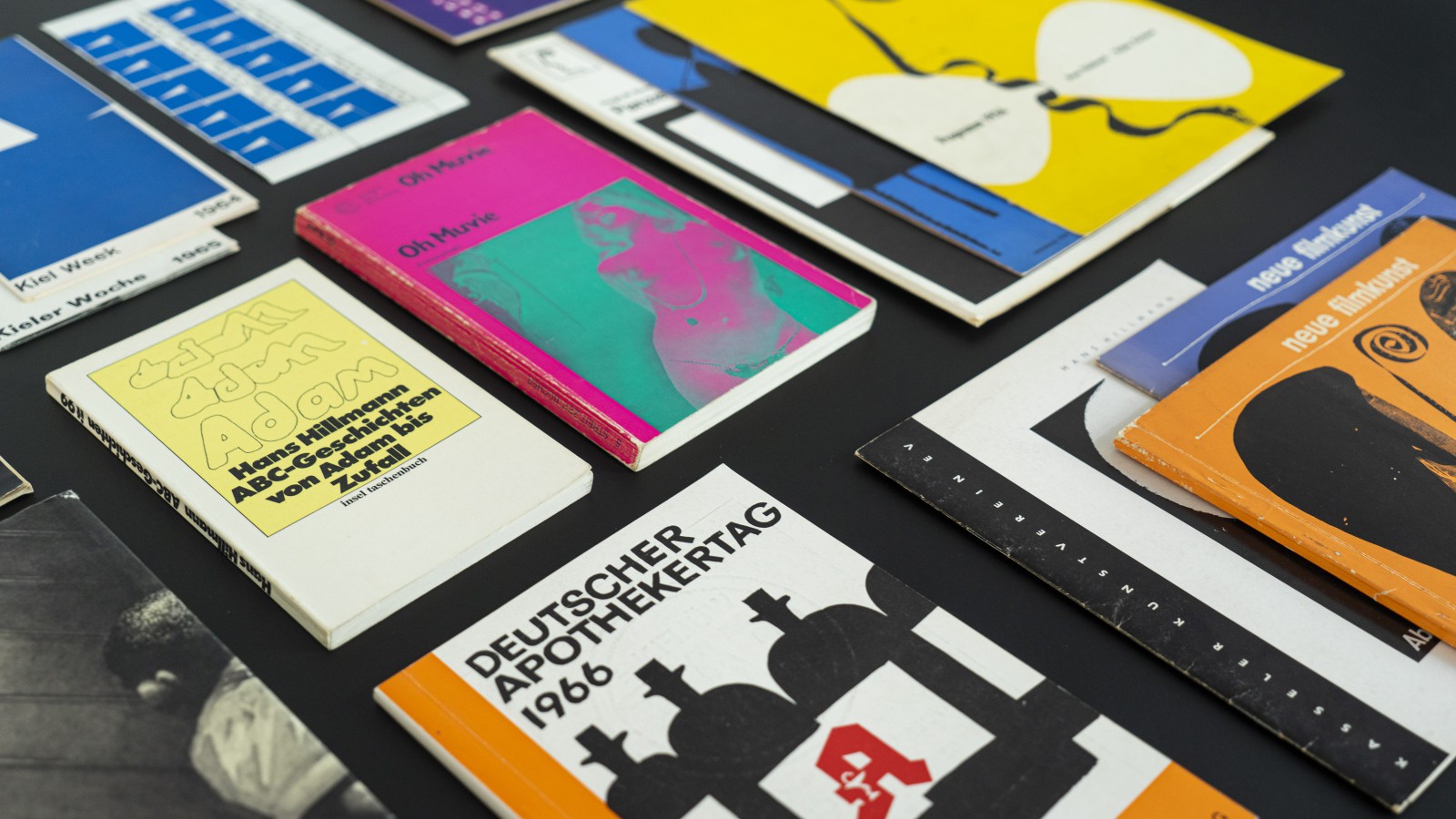 Top view of several of Hans Hillmann's printed works: movie posters, book covers, and program booklets